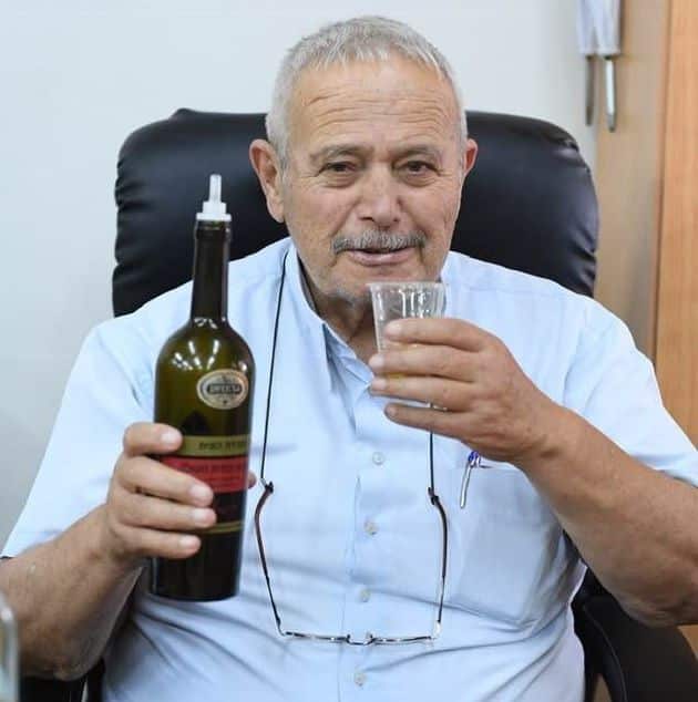 אבו נאסר ראש משפחת ג'השאן טועם משמן הזית הראשון של השנה
